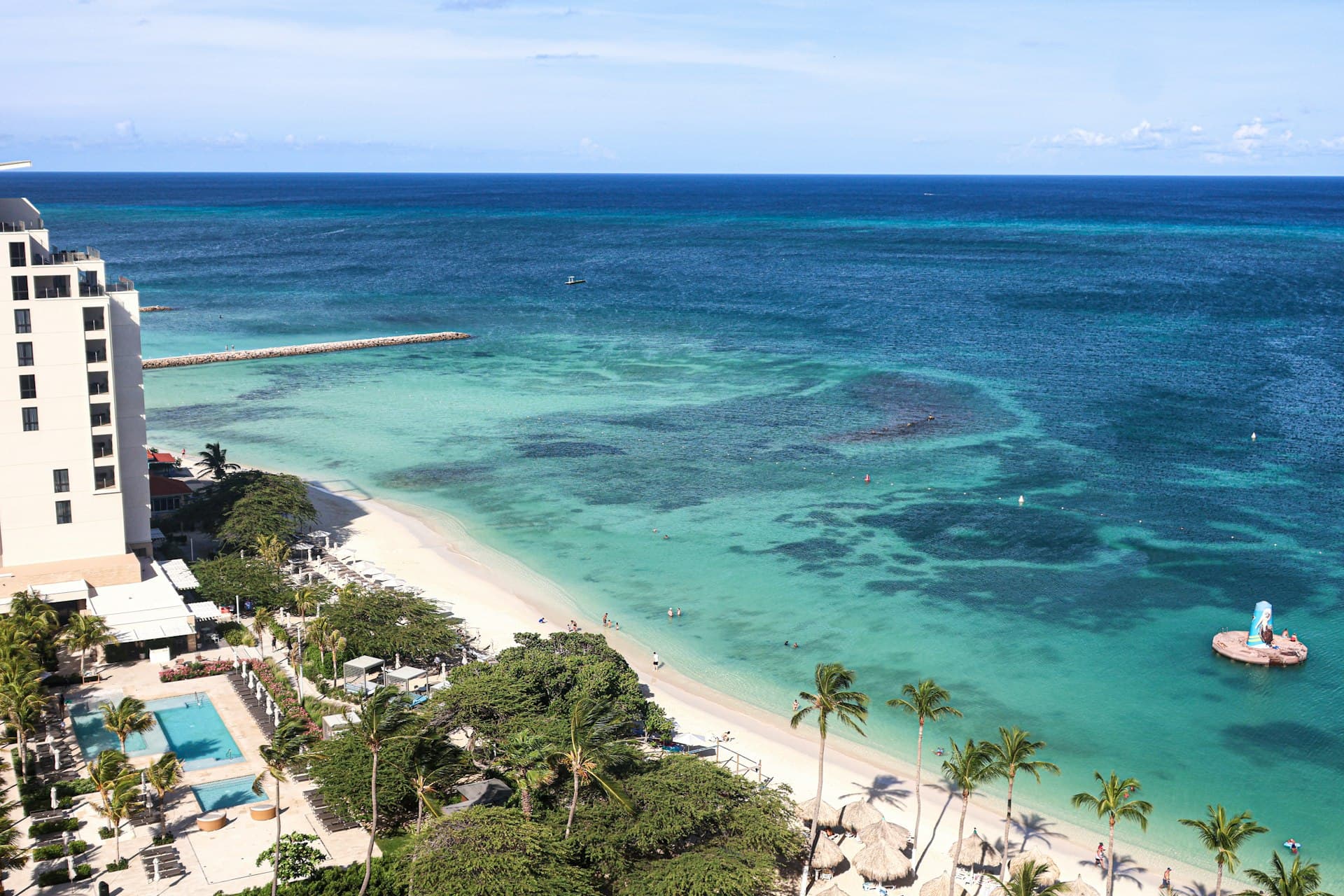 Aerial view of turquoise Caribbean waters and white sand beach in Aruba