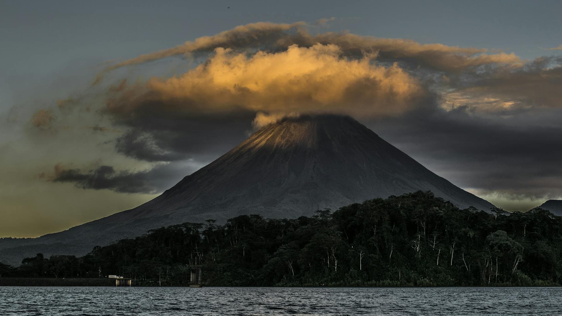 Arenal Volcano rising above the Costa Rican rainforest at dusk