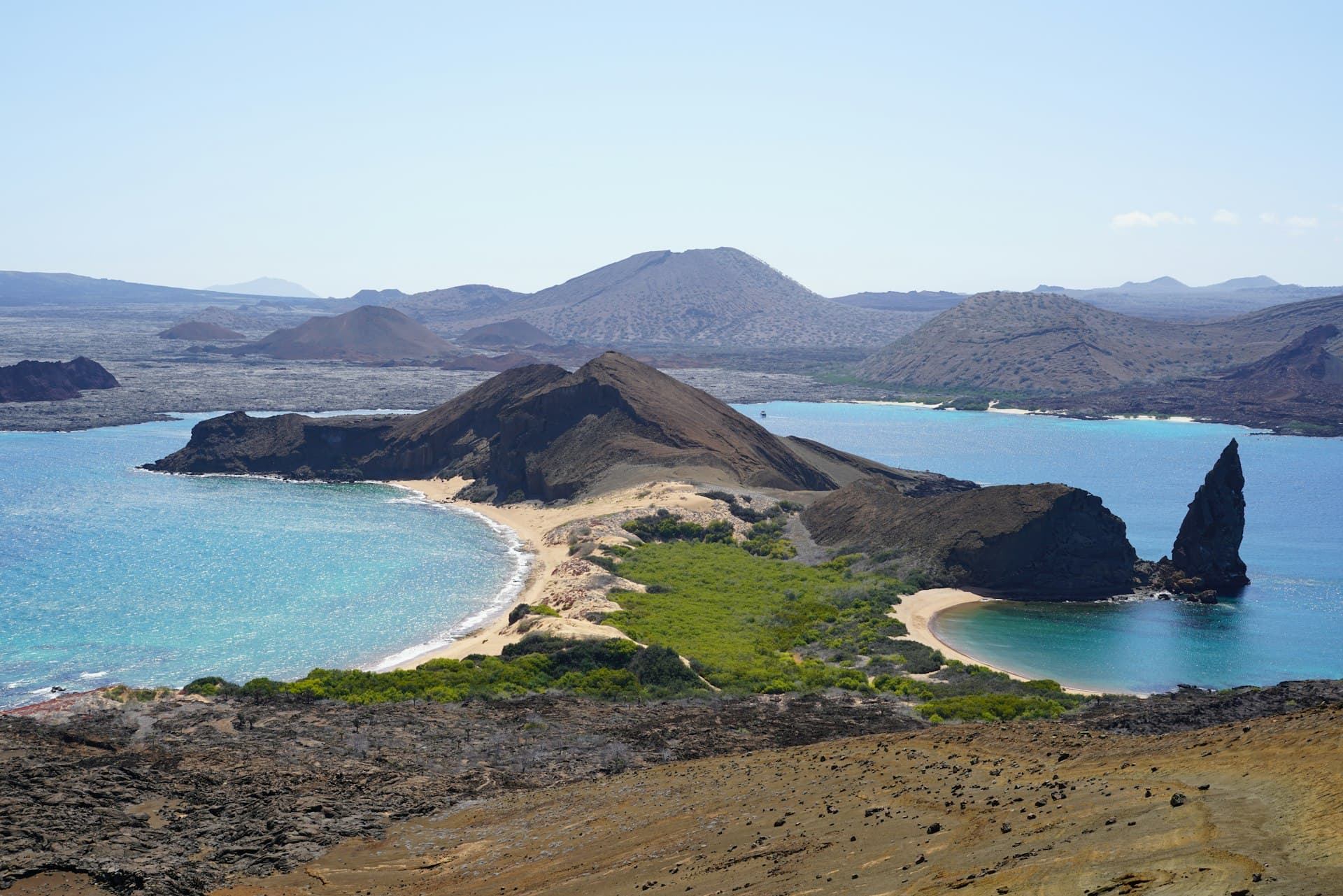 Panoramic view of Bartolome Island with Pinnacle Rock and turquoise bays in the Galapagos Islands