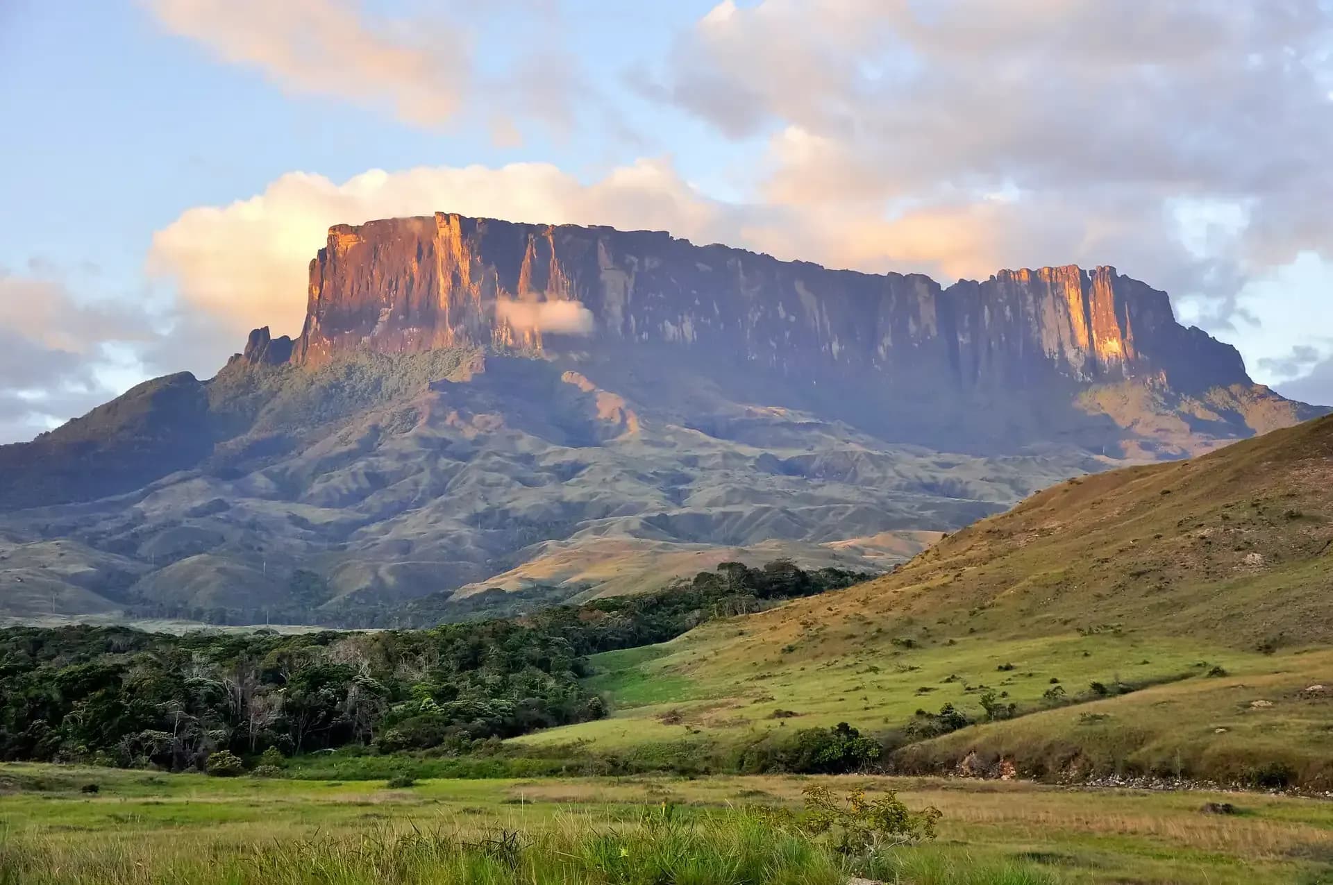 Golden sunset light casting dramatic shadows across Mount Roraima's cliff face in Venezuela