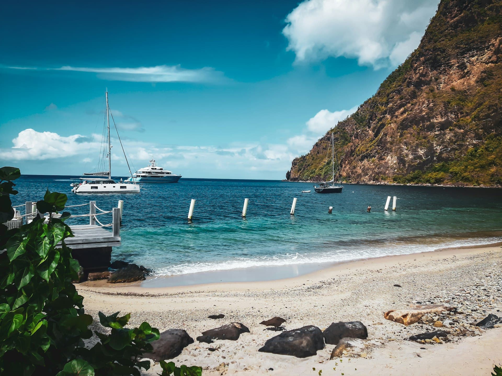 Beach with yachts anchored beneath the Pitons on the Caribbean coast of Saint Lucia