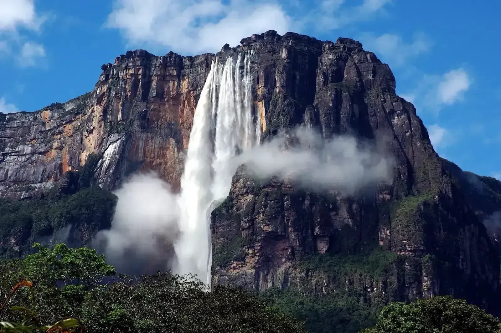 Angel Falls plunging from Auyantepui tepui surrounded by mist in Canaima National Park, Venezuela