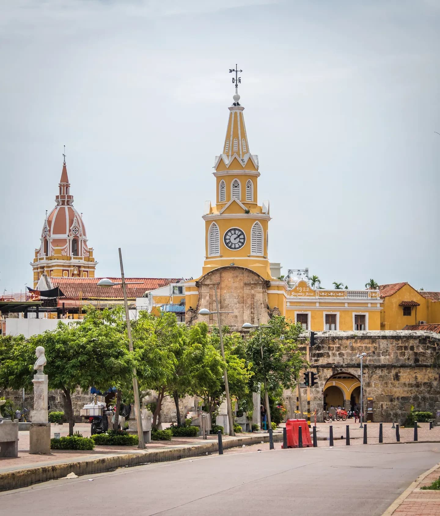 The yellow Clock Tower gate and the cathedral dome above the walled city of Cartagena, Colombia