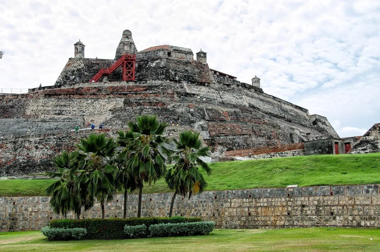 The walls of the San Felipe fortress behind palm trees in Cartagena, Colombia