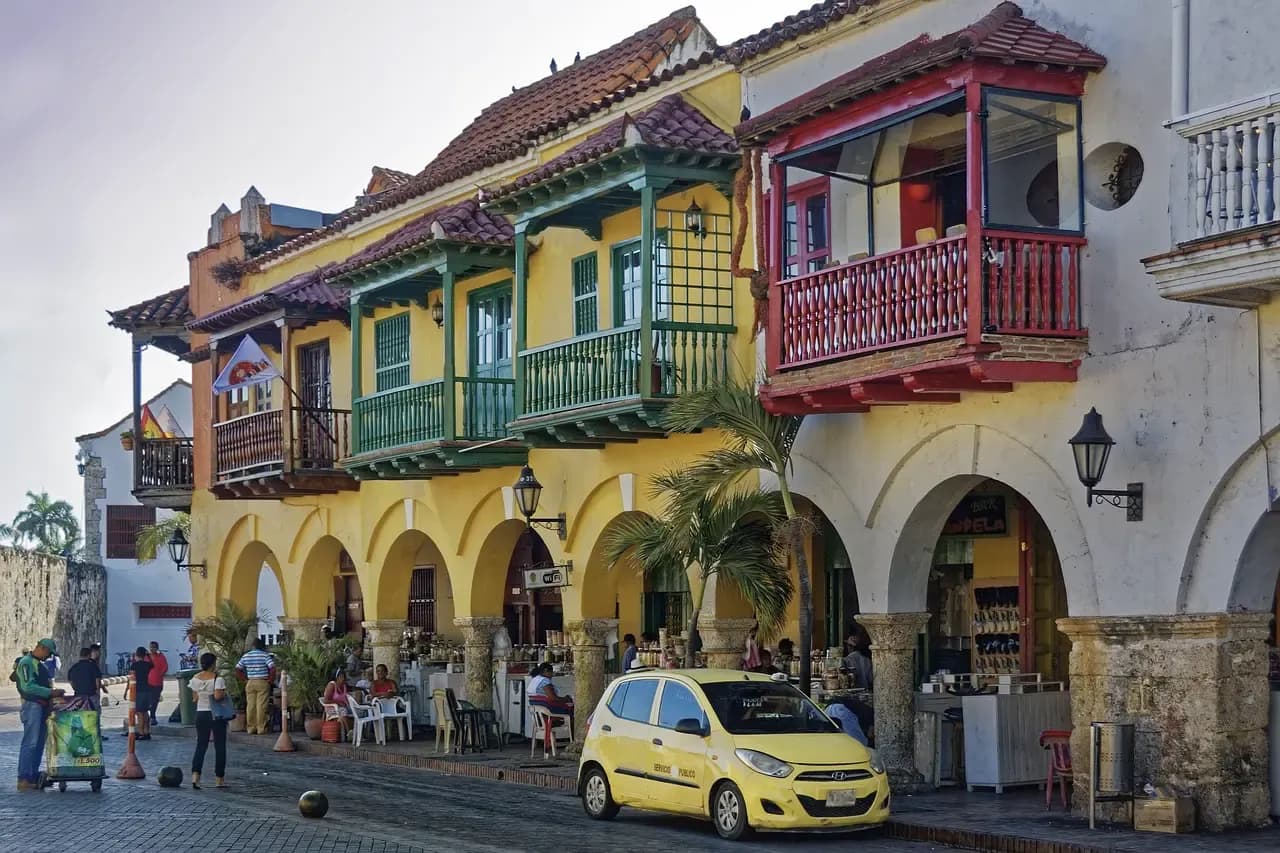 Colourful colonial buildings with wooden balconies and arches on a plaza in Cartagena, Colombia