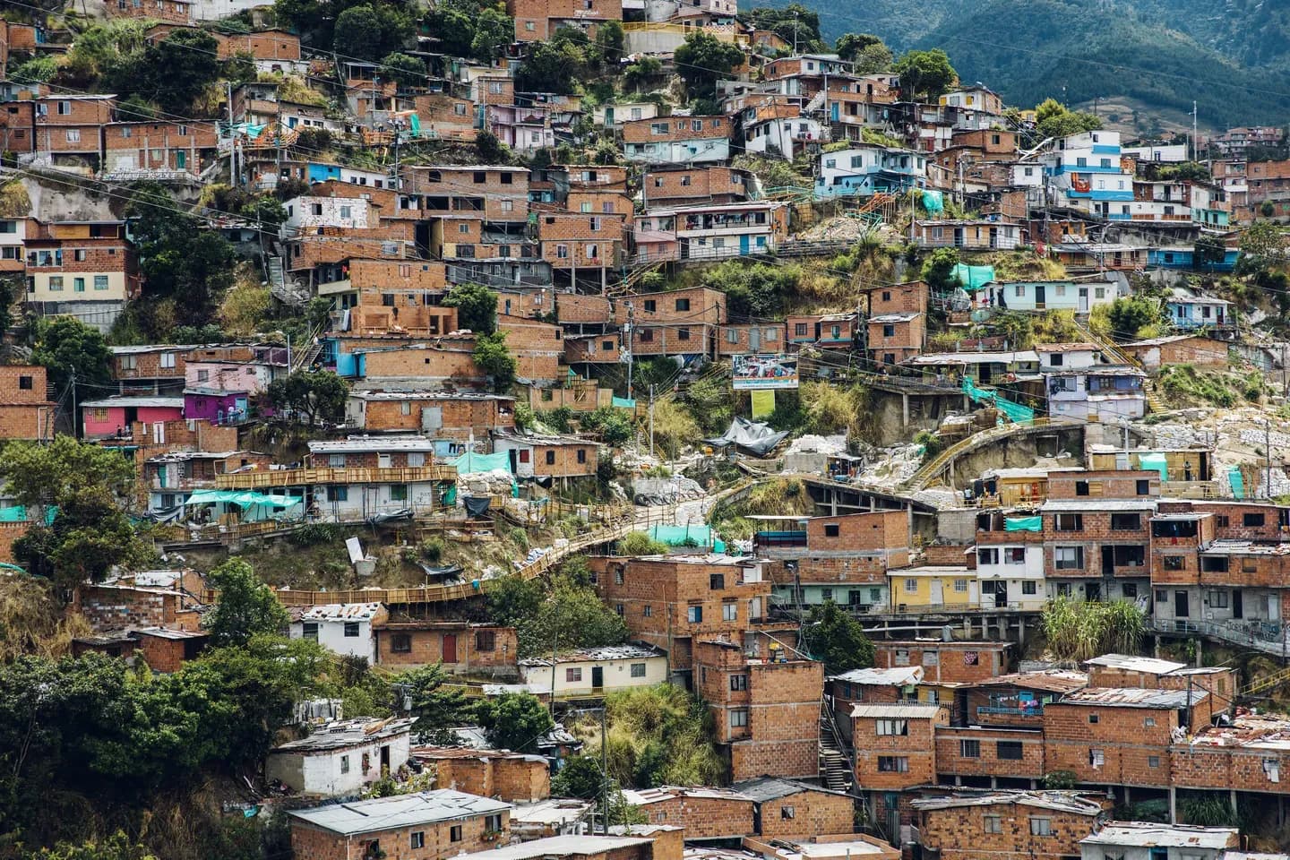 Brick houses climbing the hillside of Comuna 13 in Medellín, Colombia