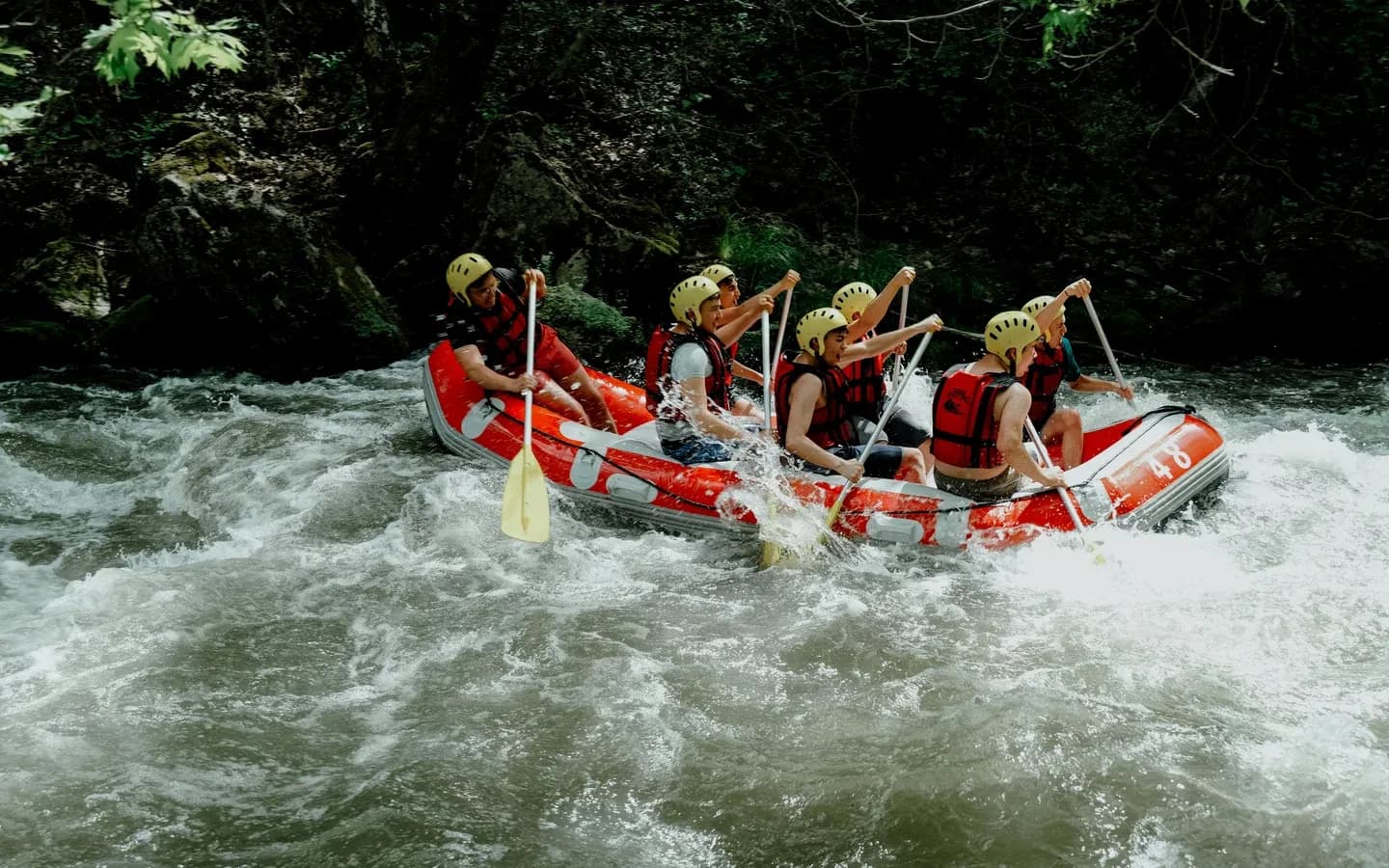 White-water rafting through a forested river gorge in Costa Rica
