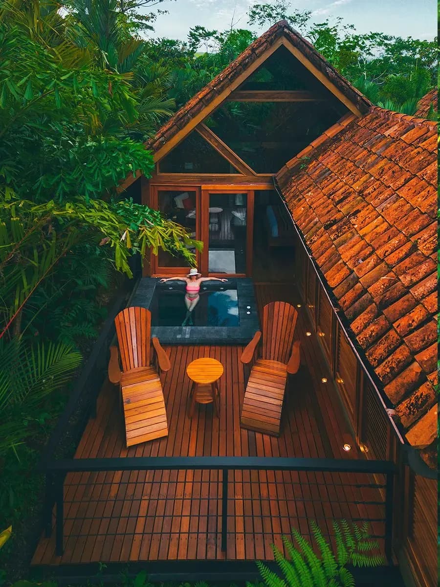 A Canyon Casita at Amor Arenal seen from above, with its private terrace, two chairs and heated plunge pool in the forest