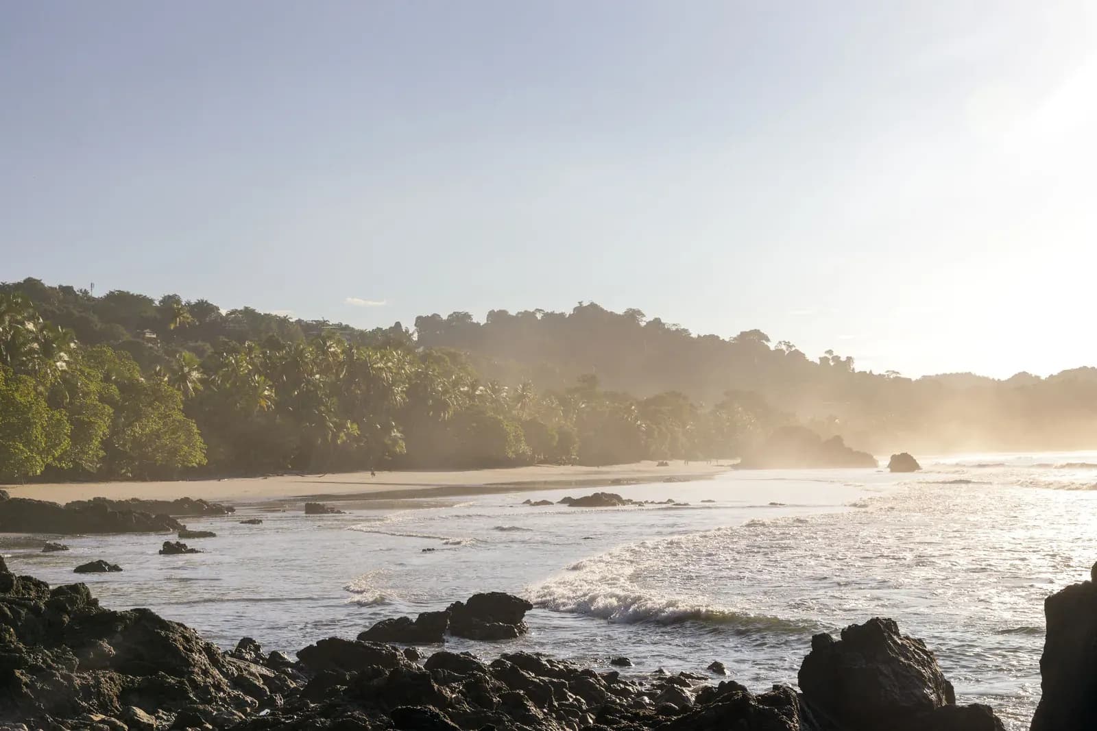 Golden light on the beach and forested headland below Arenas del Mar, Manuel Antonio