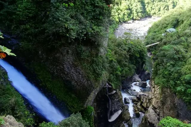 The Pailón del Diablo waterfall crashing into a green gorge near Baños, Ecuador