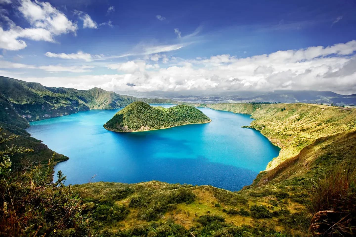 Cuicocha crater lake with its two green islands under a blue sky, Imbabura, Ecuador