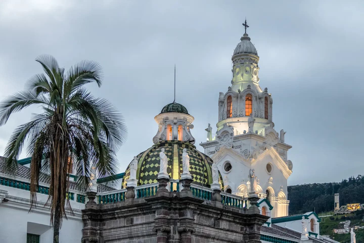 The white bell tower and green-tiled domes of the Metropolitan Cathedral, Quito, Ecuador