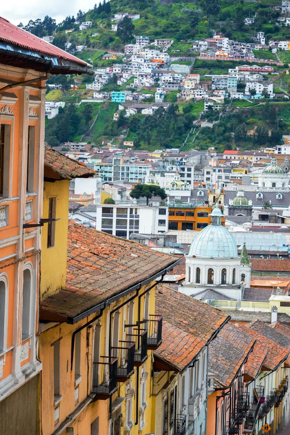 Colourful colonial balconies and a church dome in Quito's old town, Ecuador