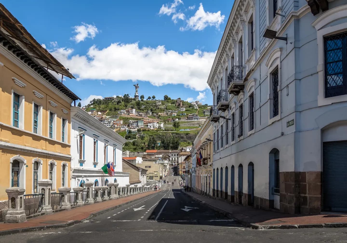 A street of colonial houses in old Quito, with the Virgin of El Panecillo on the hill beyond, Ecuador