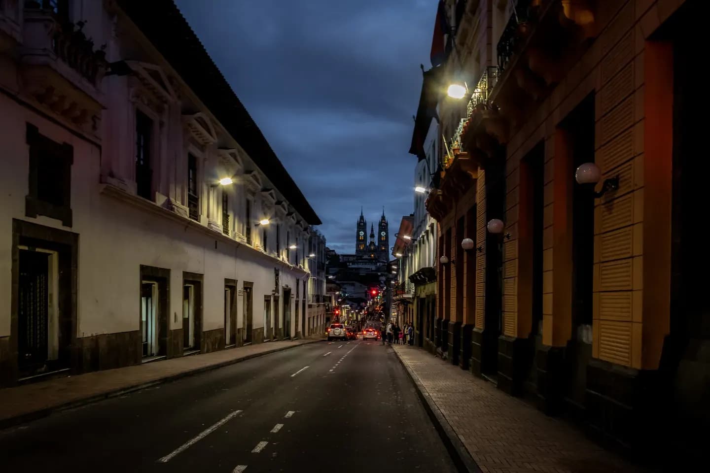A street in old Quito at dusk, with the towers of the Basílica del Voto Nacional at the end, Ecuador