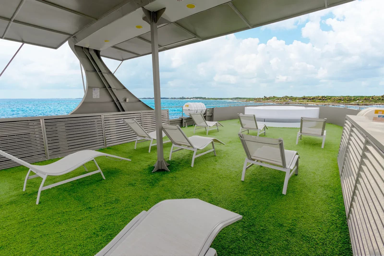 Sun deck with loungers and a jacuzzi aboard Galaxy Diver II, Galápagos