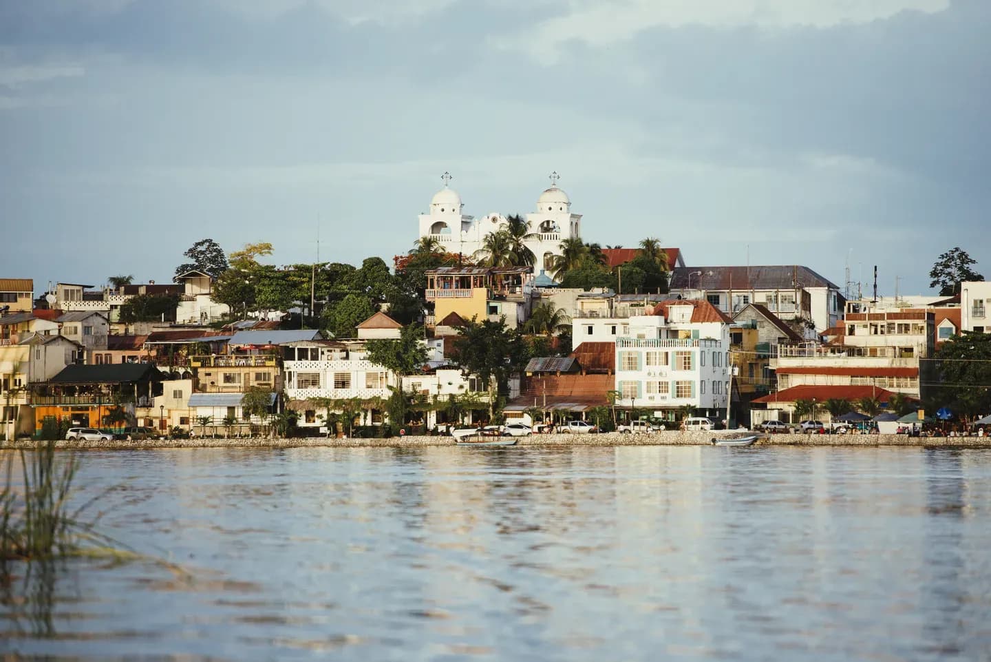 White church towers above the lakeside houses of Flores, the island town near Tikal, Guatemala
