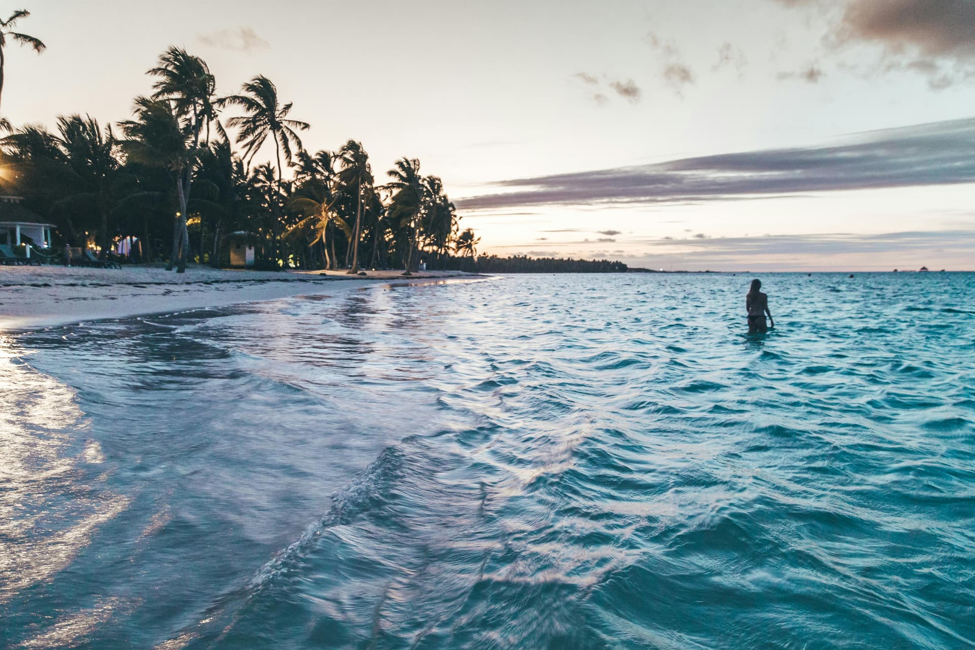 Person walking on a pristine white sand beach in the Dominican Republic