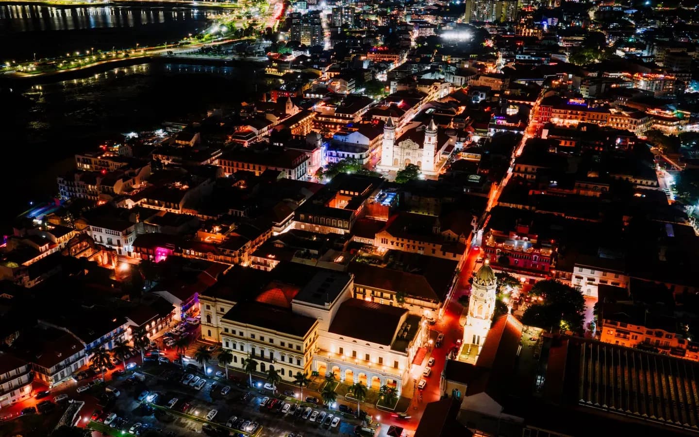 Aerial night view over the rooftops and lit streets of Casco Viejo, Panama City