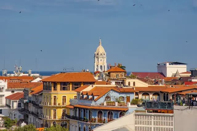 Red-tiled rooftops and the cathedral bell tower of Casco Antiguo under a blue sky, Panama City