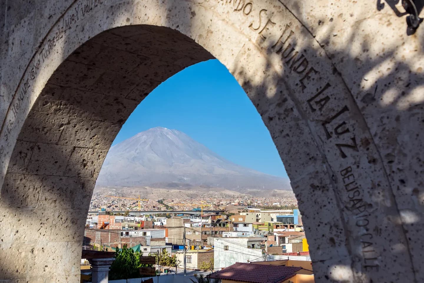 El Misti volcano framed by a white sillar stone arch above Arequipa, Peru