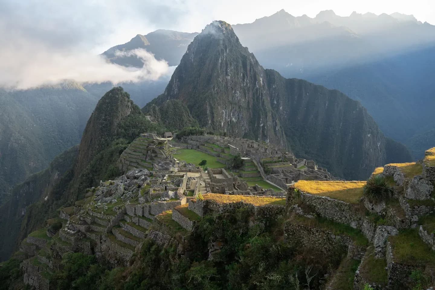 Morning sun breaking over Machu Picchu and Huayna Picchu, Peru