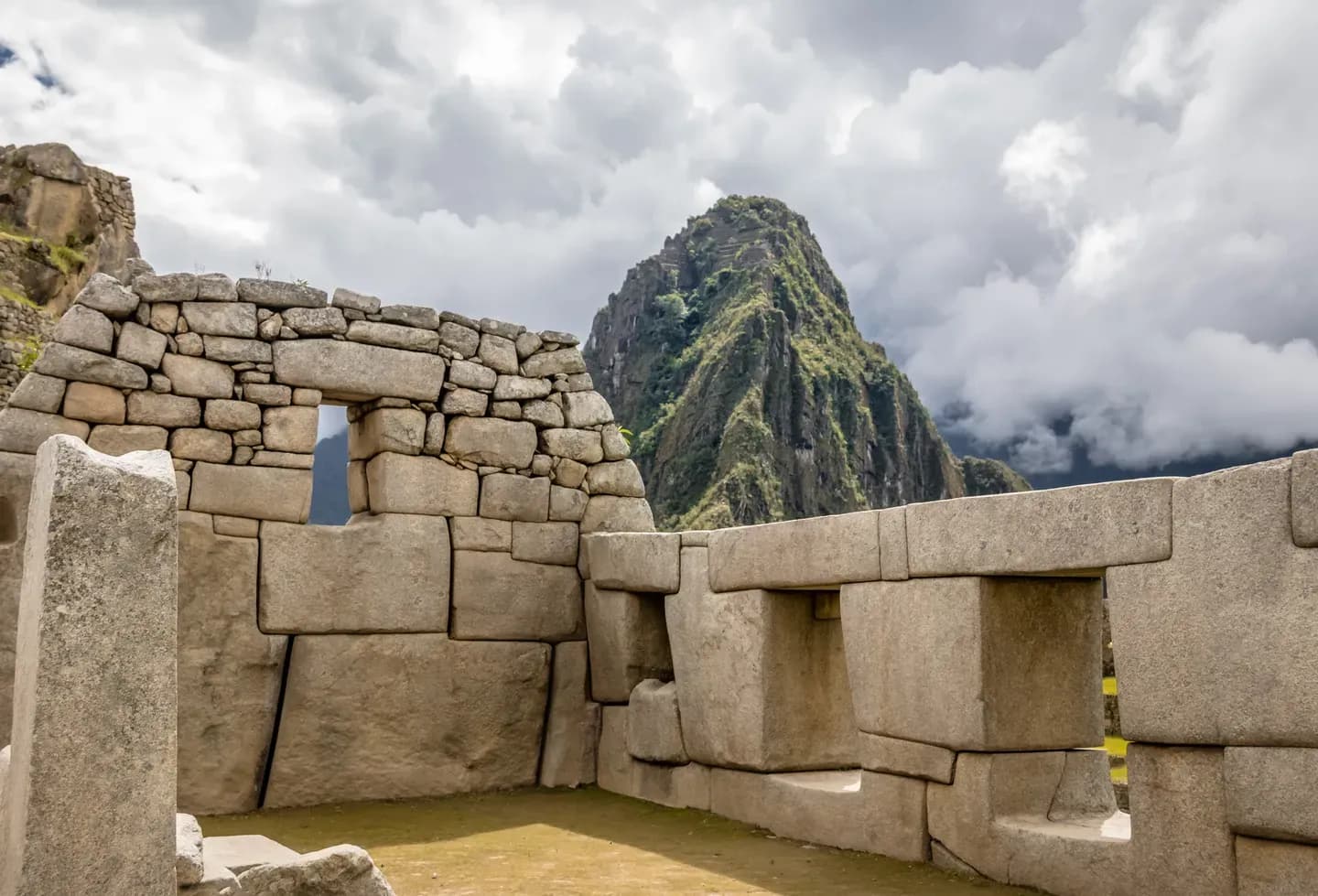 The Temple of the Three Windows at Machu Picchu, with Huayna Picchu behind, Peru