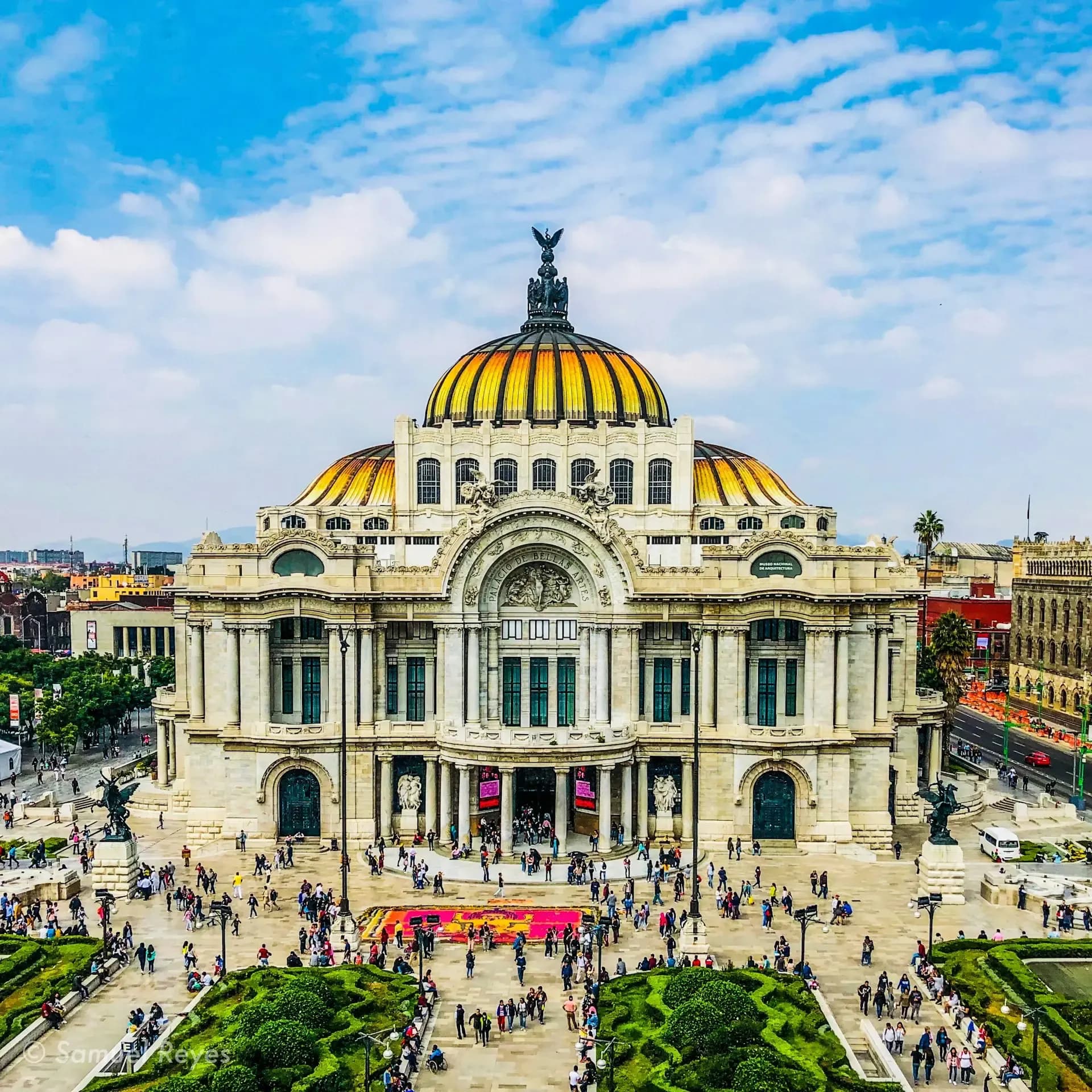 Palacio de Bellas Artes in Mexico City with its iconic golden dome under a blue sky