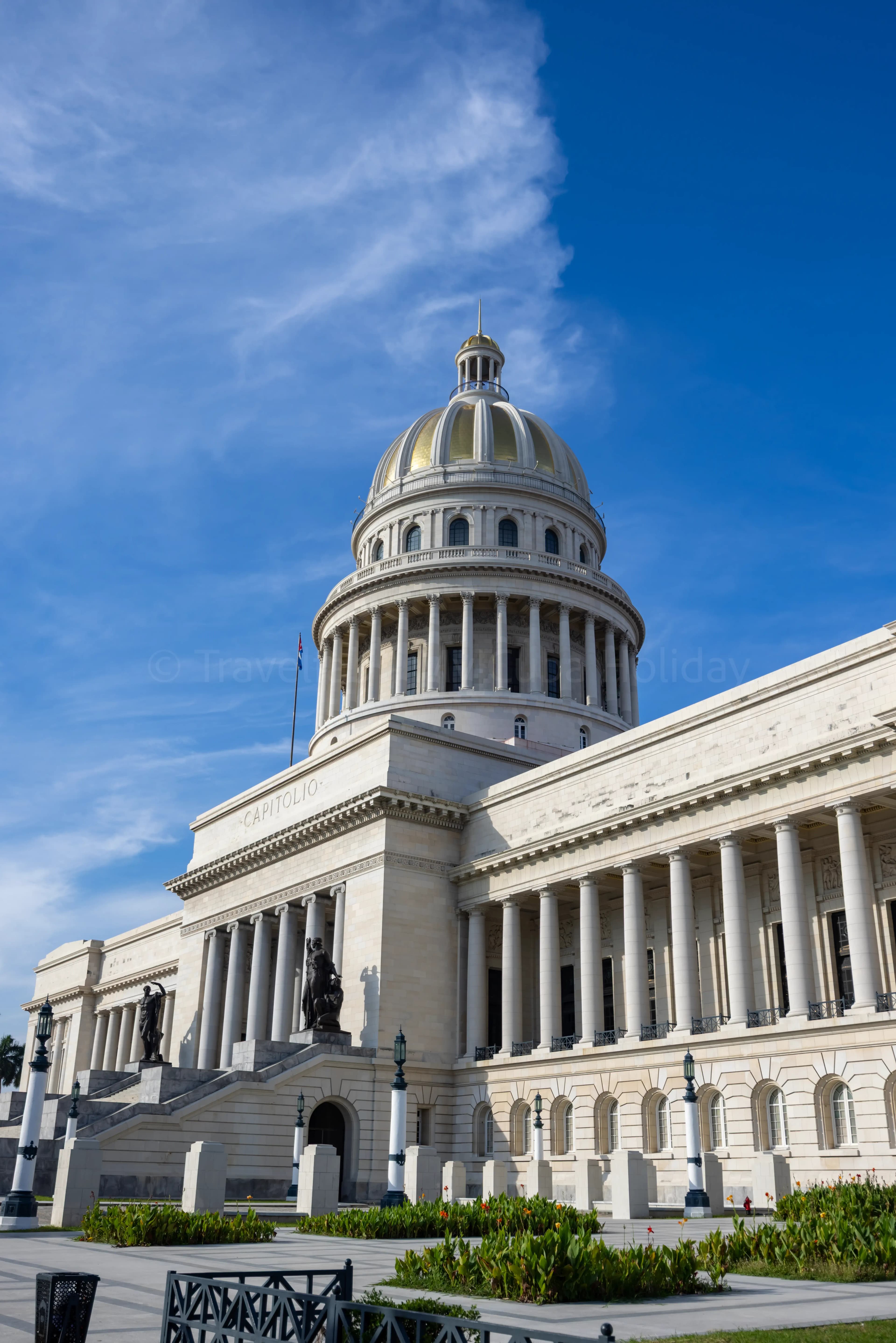 El Capitolio building in Havana, Cuba, with its golden dome against a blue sky