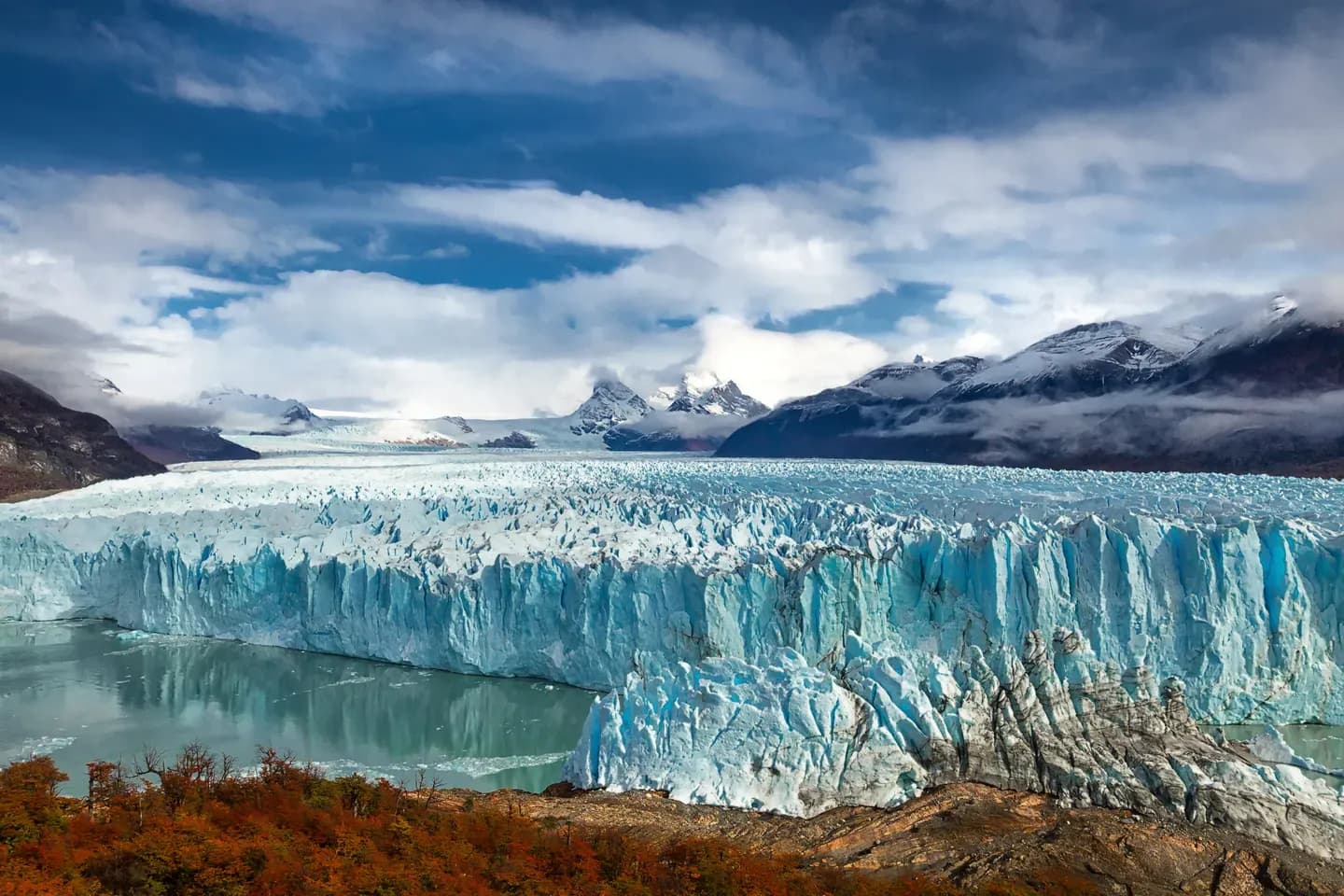 The Perito Moreno glacier meeting Lago Argentino below snow-capped peaks, Los Glaciares National Park, Argentina
