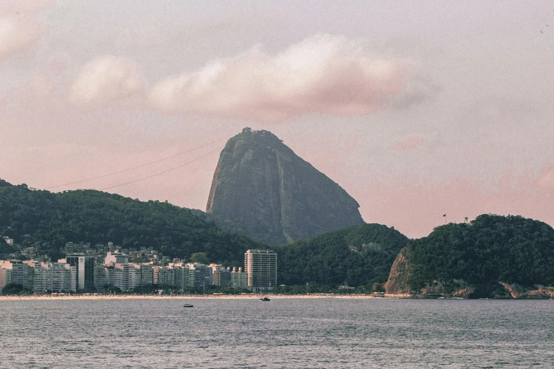 Sugarloaf Mountain rising above the beachfront and bay of Rio de Janeiro, Brazil, at golden hour