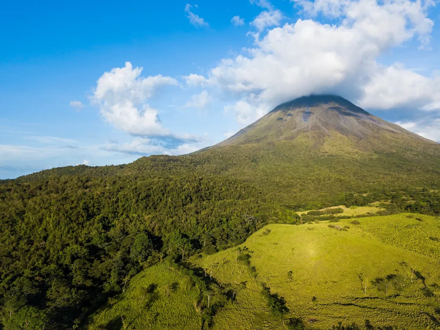The cone of Arenal Volcano rising above green foothills and rainforest, Costa Rica