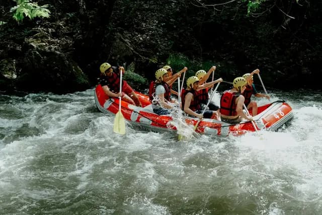 White-water rafting through a forested river gorge in Costa Rica