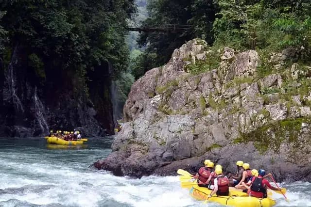 White-water rafting through a forested river canyon in Costa Rica