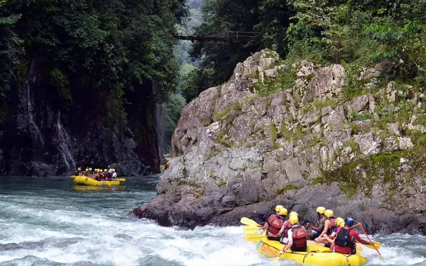 White-water rafting through a forested river canyon in Costa Rica
