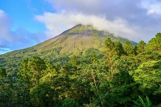 Arenal Volcano rising above lush rainforest, Costa Rica