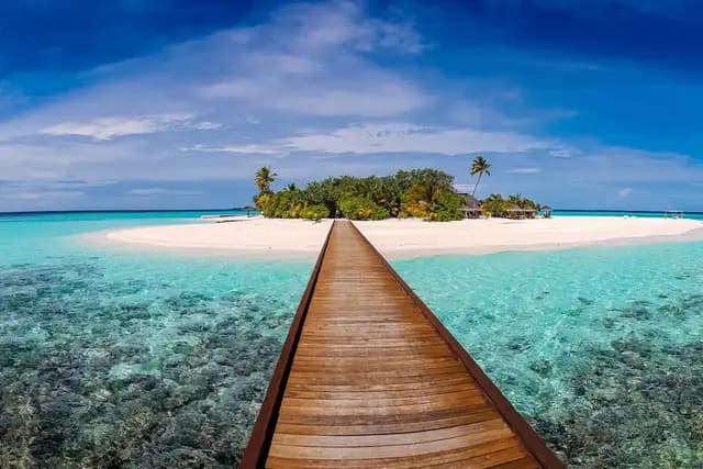 Sandy beach and turquoise water at Cabarete, Dominican Republic with kites in the sky