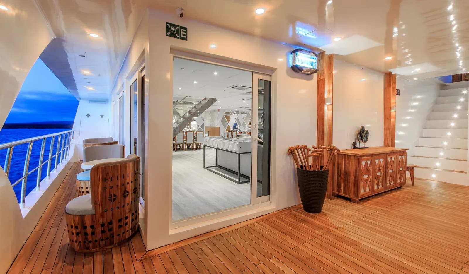 The deck corridor aboard the Elite catamaran lit up in the evening, Galápagos