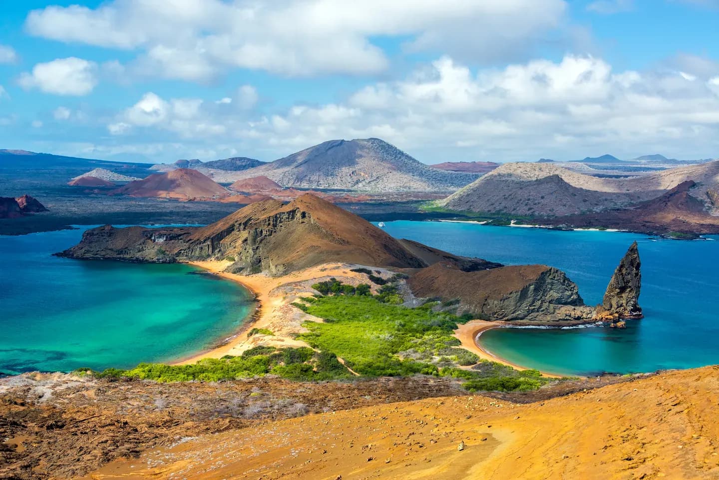 The view from Bartolomé Island over two turquoise bays and Pinnacle Rock, Galápagos Islands