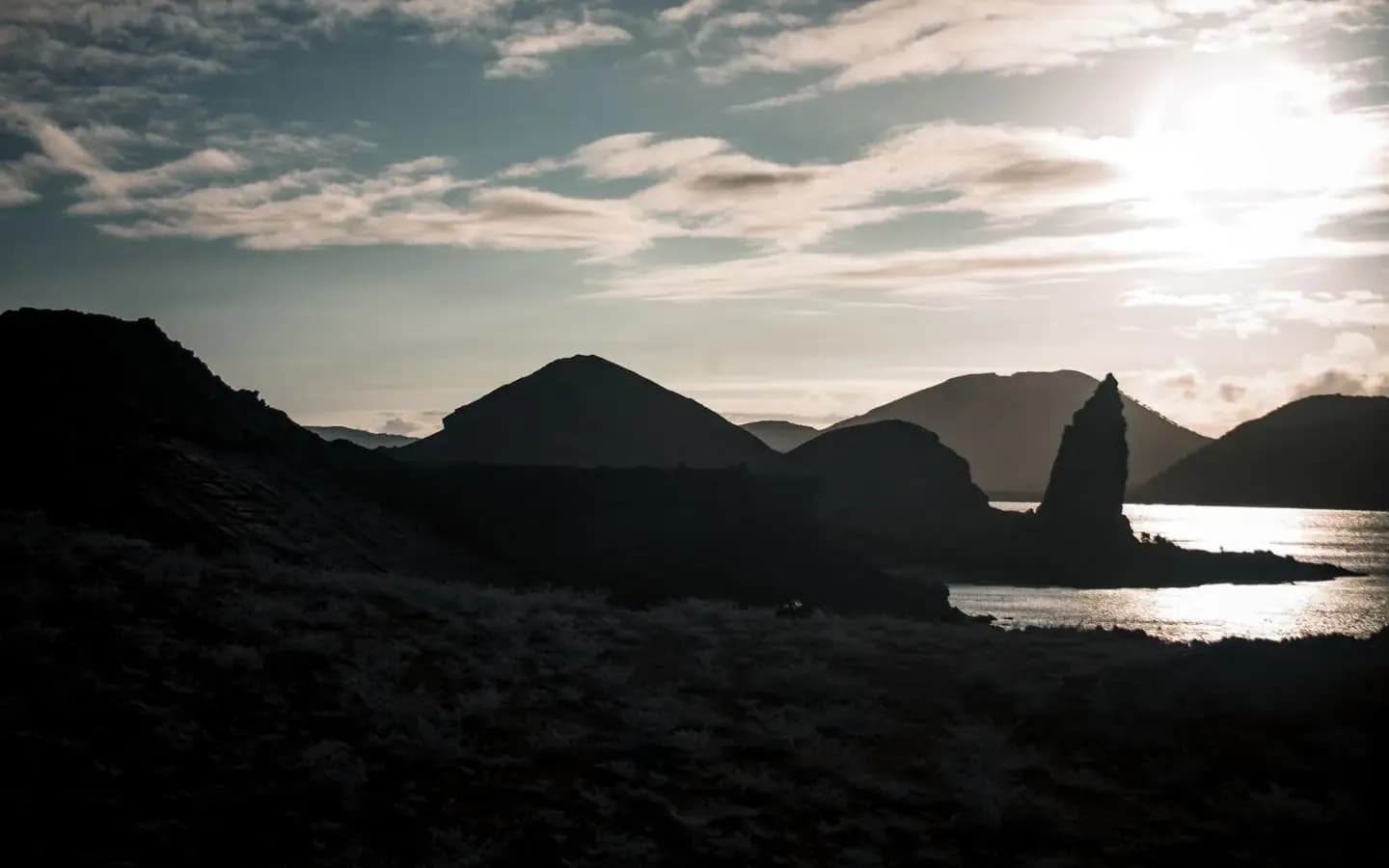 Pinnacle Rock and volcanic cones at sunset on Bartolome Island, Galapagos