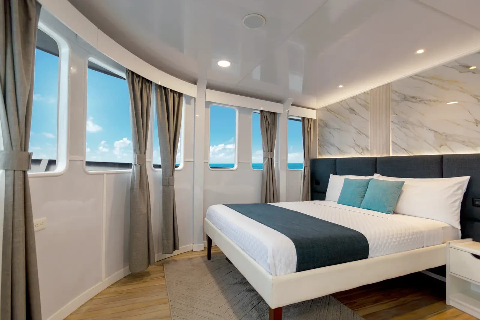 Cabin with a curved five-pane panoramic bow window bay aboard Galaxy Diver II, Galápagos