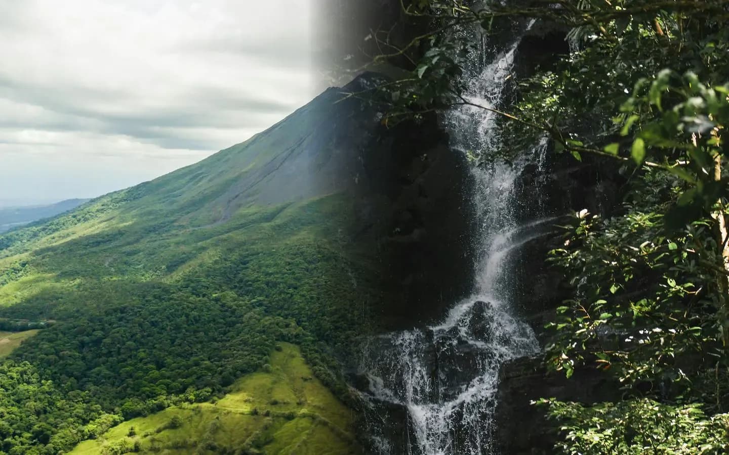 Arenal Volcano rising above lush green rainforest beside a jungle waterfall in Costa Rica