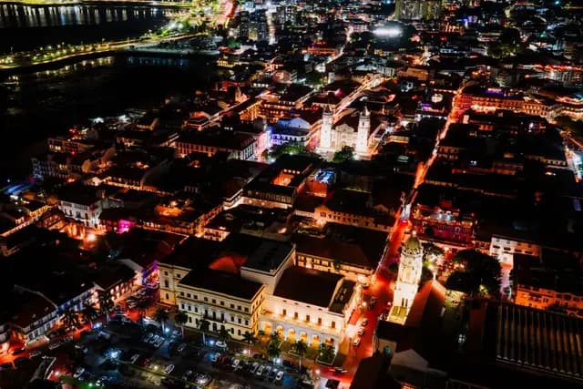 Aerial night view over the rooftops and lit streets of Casco Viejo, Panama City