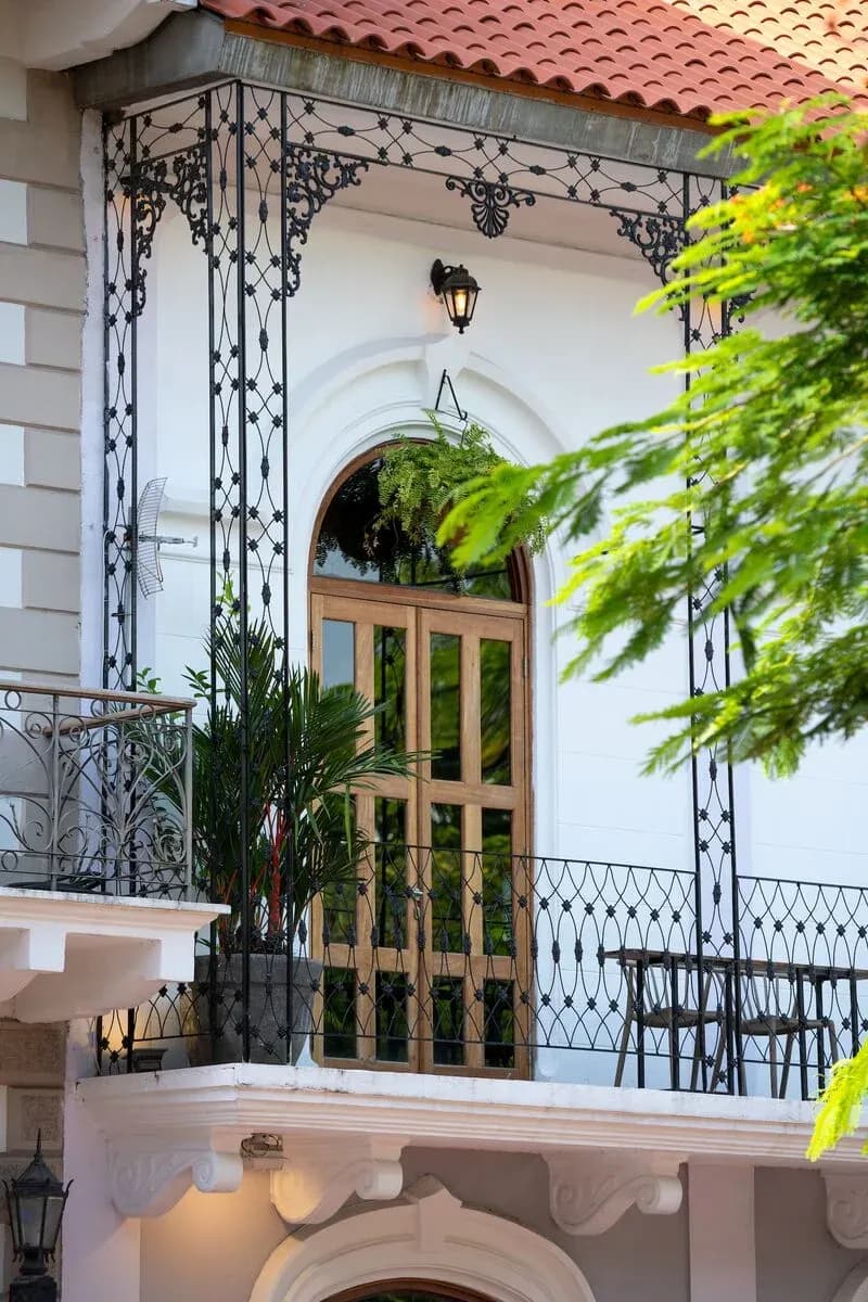 Wrought-iron balcony and wooden doors on a restored colonial facade in Casco Antiguo, Panama City