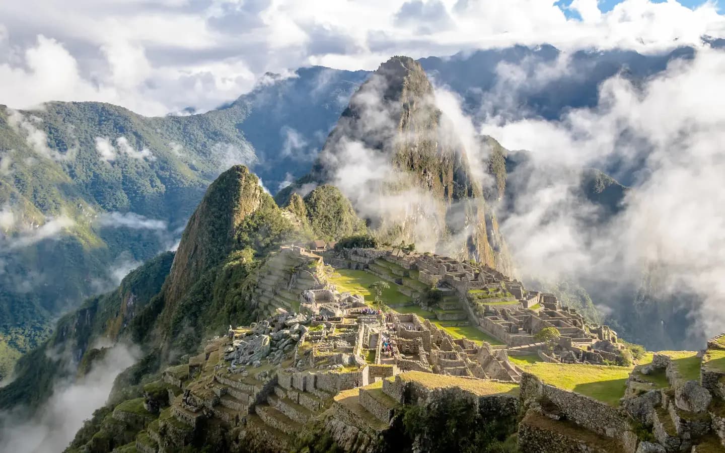 The Inca citadel of Machu Picchu below Huayna Picchu, with clouds rising from the valley, Peru