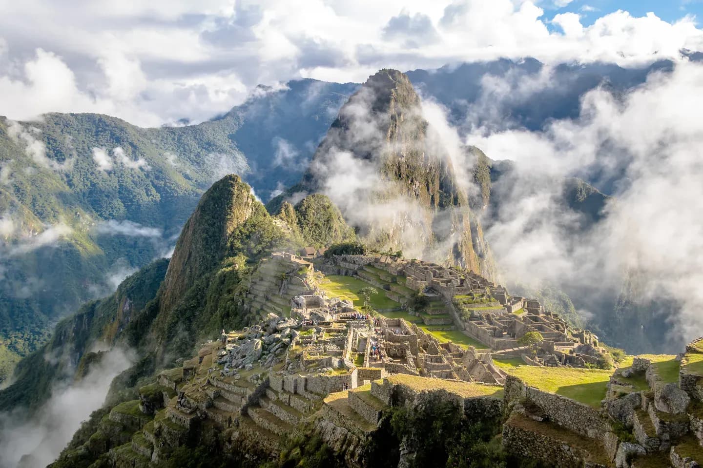 The Inca citadel of Machu Picchu below Huayna Picchu, with clouds rising from the valley, Peru