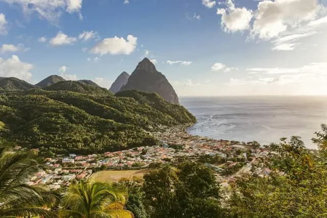 The twin Pitons rising above Soufriere and the Caribbean Sea in Saint Lucia