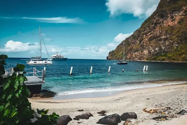 Beach with yachts anchored beneath the Pitons on the Caribbean coast of Saint Lucia