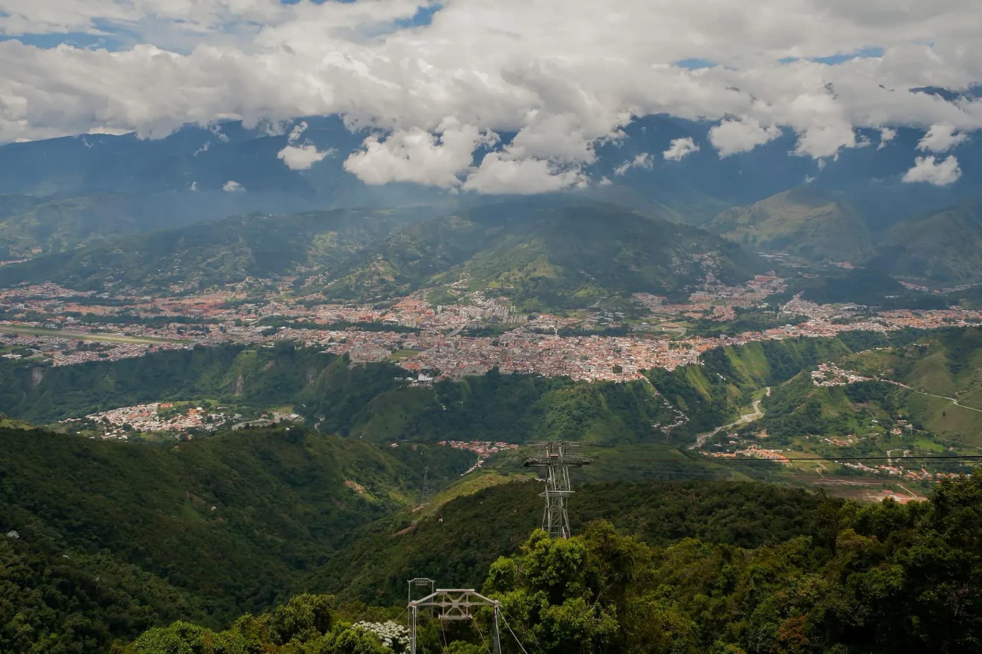 The city of Mérida set in a green valley beneath the cloud-wrapped peaks of the Sierra Nevada in the Venezuelan Andes